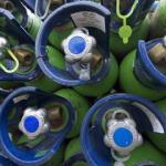 Blue tops of green gas bottles