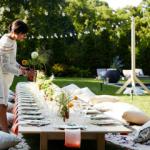 Outdoor party table with cushion seating in sunny garden