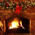 A roaring fire with Christmas decorations around the mantelpiece