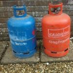 A blue and a red Calor Gas Cylinder