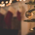 Sparkly golden bauble hanging on a Christmas tree