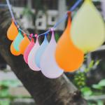 Balloons hanging on a string in a garden